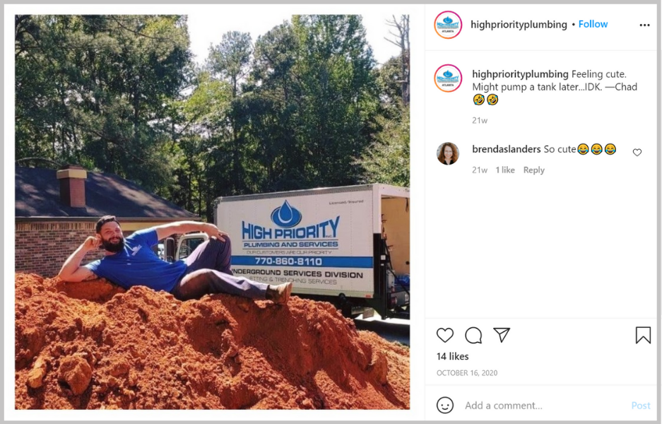 Man sitting on top of a pile of dirt playing