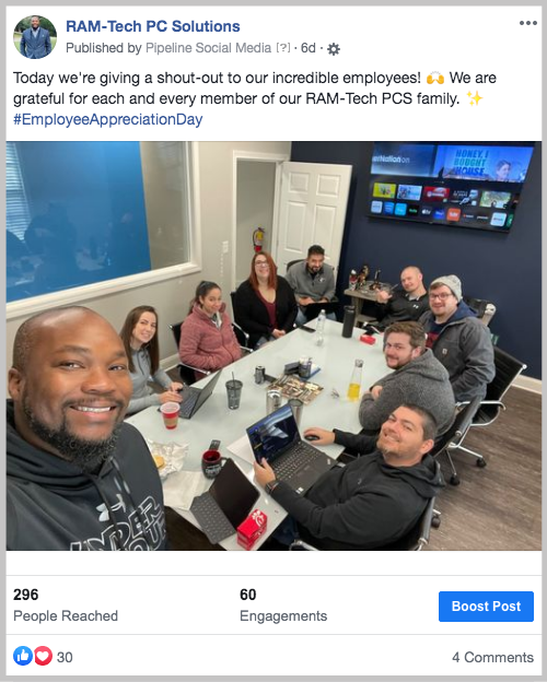 Coworkers sitting at a table for a meeting and taking a selfie