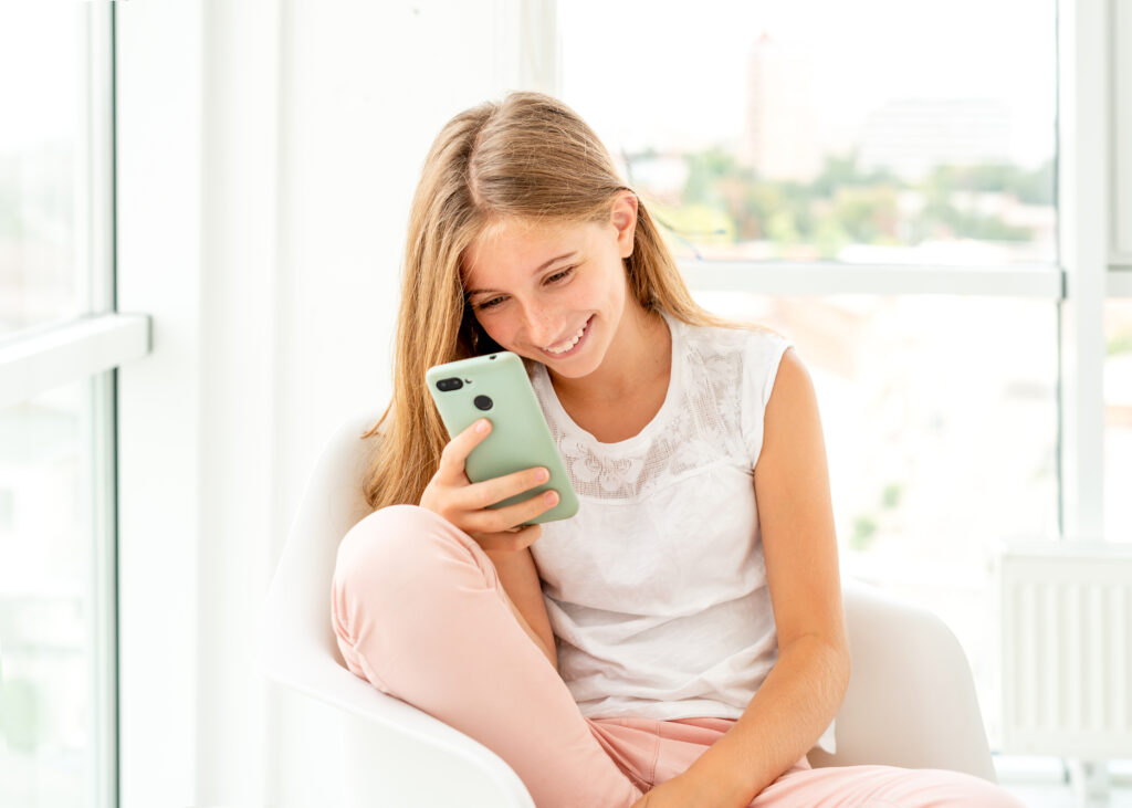 teen girl looking at mobile phone